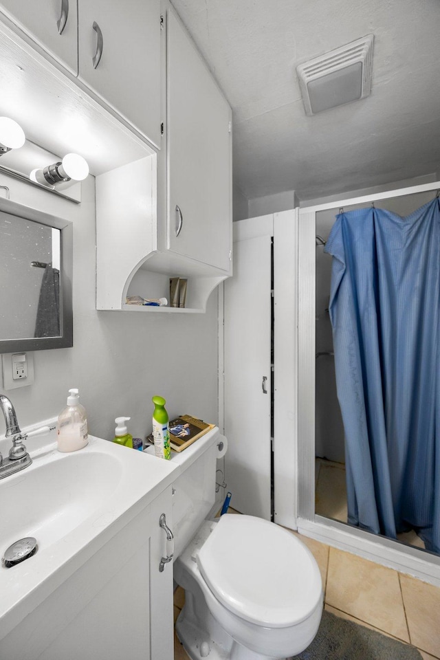 1114 6th St, Mankato, MN 56001 - bathroom featuring vanity, tile patterned flooring, and toilet