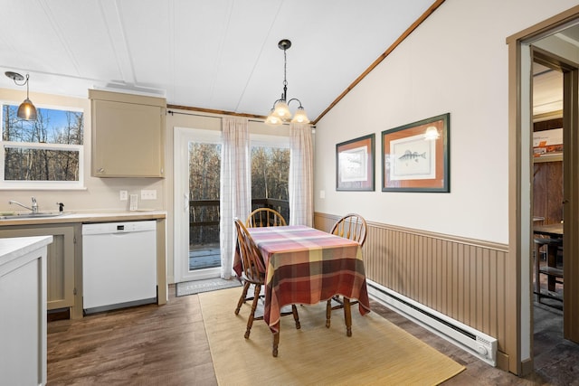 dining area featuring a baseboard radiator, wood finished floors, a chandelier, a wainscoted wall, and lofted ceiling
