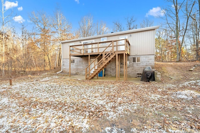 rear view of property featuring a patio, stairway, and a deck