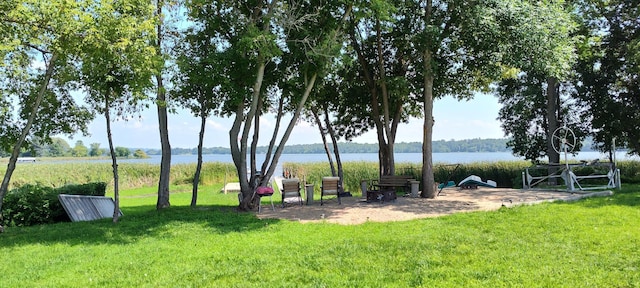 view of community with a lawn and a water view