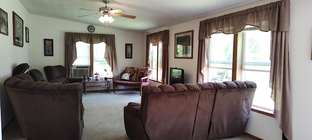 living room featuring plenty of natural light, carpet flooring, and a ceiling fan