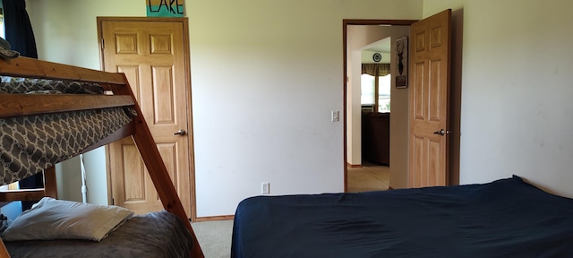 bedroom with baseboards and carpet floors