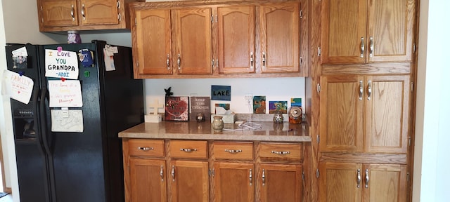bar featuring black fridge with ice dispenser