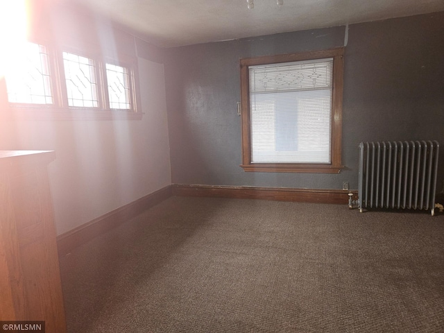 414 33rd Ave N, Minneapolis, MN 55412 - carpeted empty room featuring radiator heating unit and baseboards