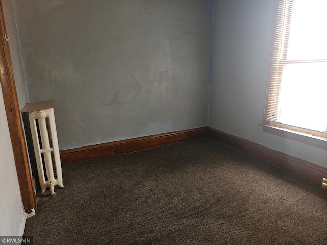 414 33rd Ave N, Minneapolis, MN 55412 - carpeted spare room featuring baseboards and radiator heating unit