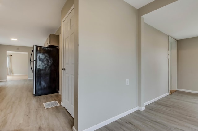 hallway featuring recessed lighting, baseboards, visible vents, and light wood-style flooring