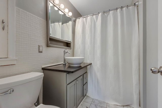 bathroom featuring curtained shower, marble finish floor, vanity, and toilet
