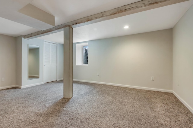 basement featuring recessed lighting, baseboards, and carpet