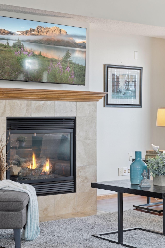 interior details featuring a tiled fireplace