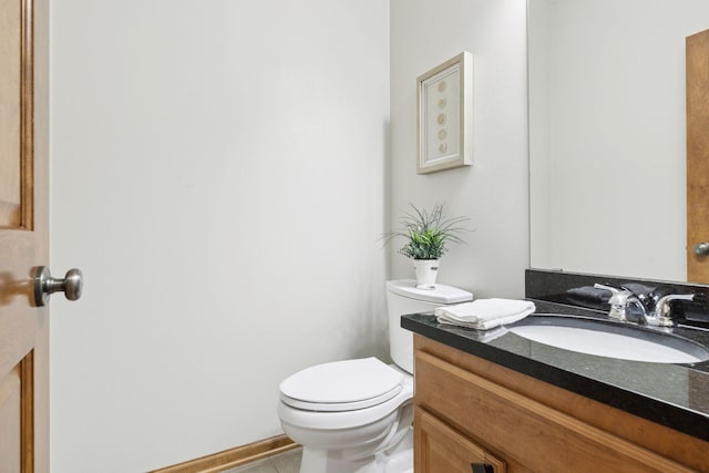 bathroom featuring toilet, tile patterned floors, and vanity