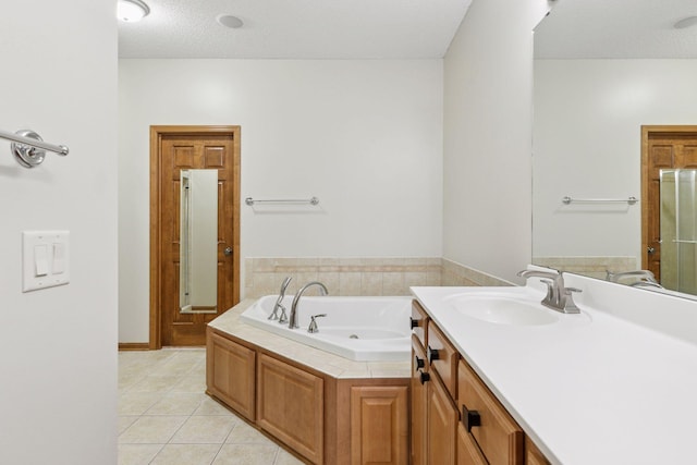 bathroom featuring vanity, tile patterned floors, and a garden tub