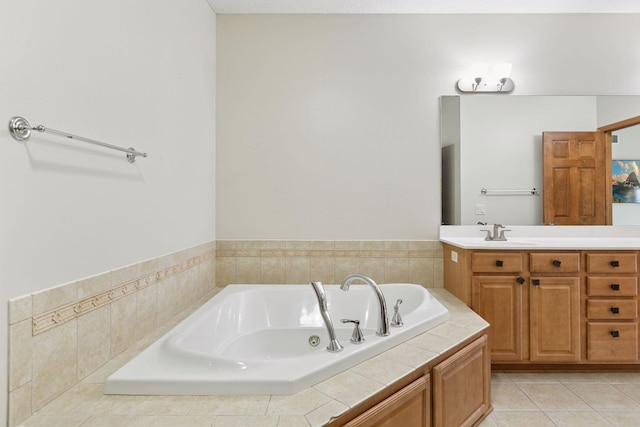 full bathroom featuring tile patterned flooring, a garden tub, and vanity