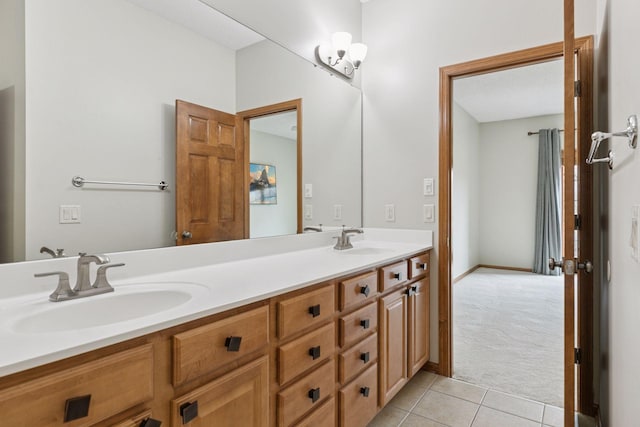 full bath featuring double vanity, a sink, and tile patterned floors