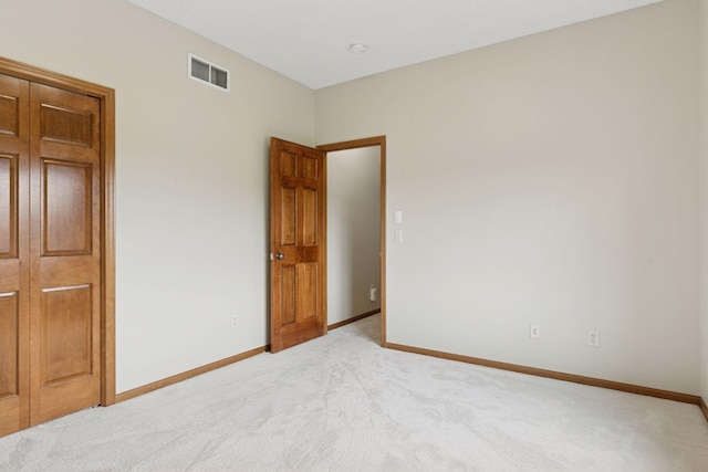 carpeted empty room with baseboards and visible vents