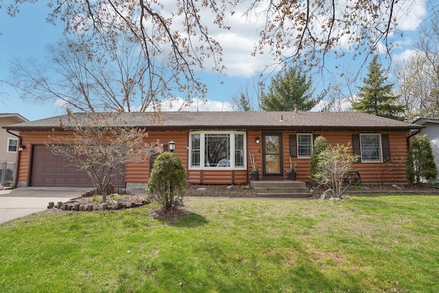 view of front of property with an attached garage, a front lawn, faux log siding, and concrete driveway