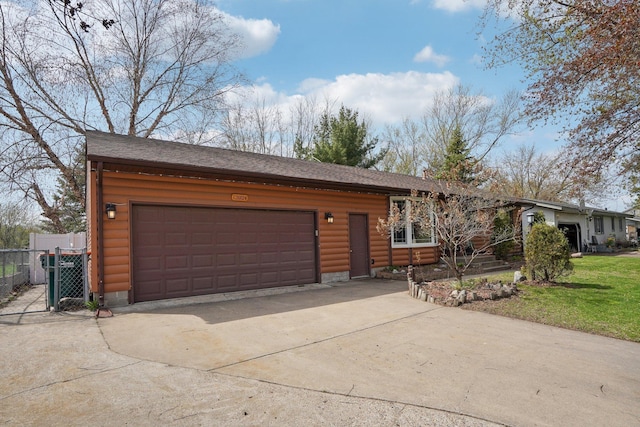 view of front facade featuring fence, driveway, roof with shingles, and a garage