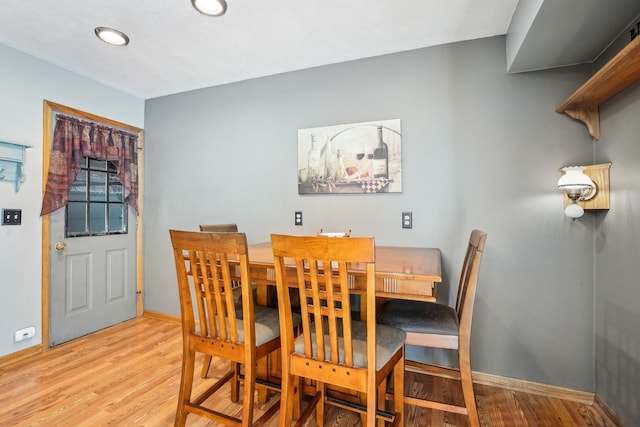 dining space with baseboards, recessed lighting, and wood finished floors