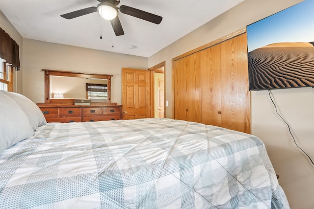 bedroom with a ceiling fan and a closet