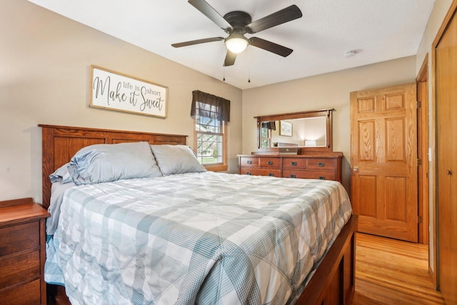 bedroom with light wood finished floors and ceiling fan
