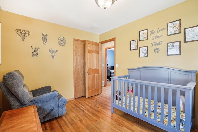 bedroom featuring baseboards and wood finished floors