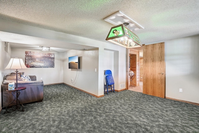 unfurnished room with visible vents, a textured ceiling, carpet, and baseboards