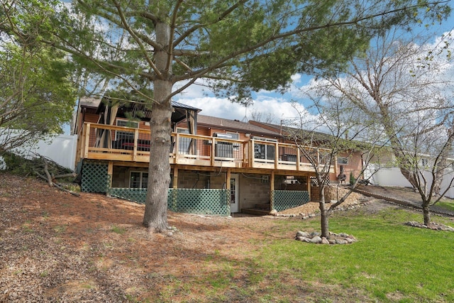back of house with a yard and a deck