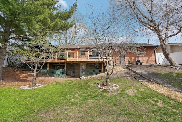 view of front of house with fence, a front yard, and a deck
