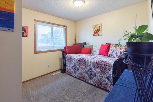bedroom with carpet floors, a textured ceiling, and baseboards