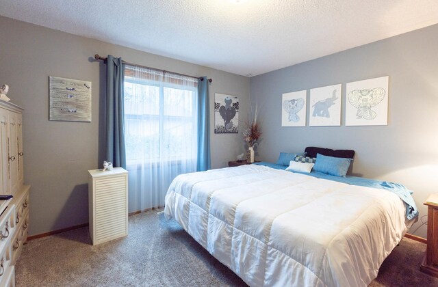 bedroom featuring carpet flooring, a textured ceiling, and baseboards