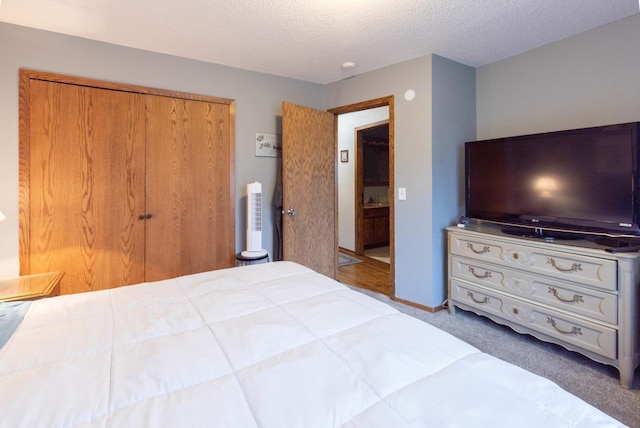 carpeted bedroom featuring a textured ceiling