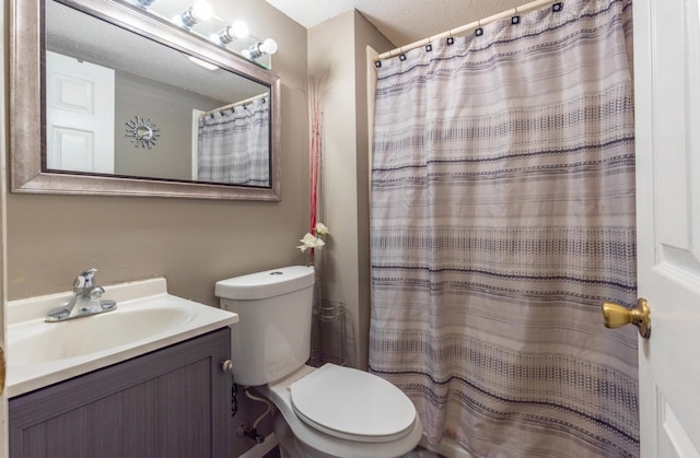 bathroom featuring vanity, toilet, and curtained shower