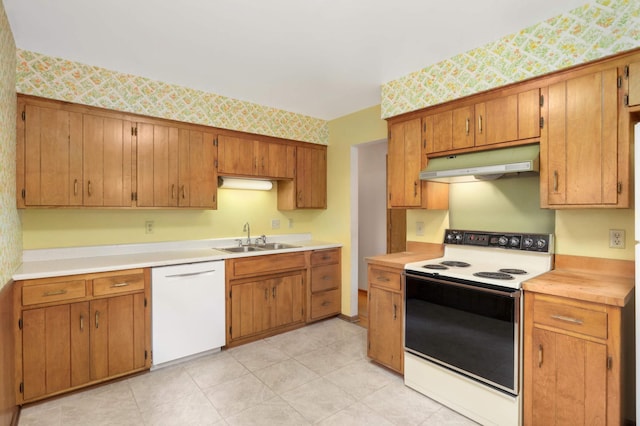 kitchen featuring a sink, white appliances, light countertops, wallpapered walls, and under cabinet range hood