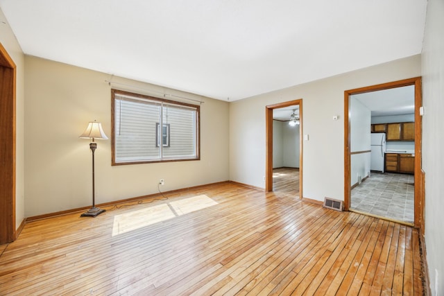 1622 Washington St NE, Minneapolis, MN 55413 - interior space featuring visible vents, baseboards, freestanding refrigerator, and wood-type flooring