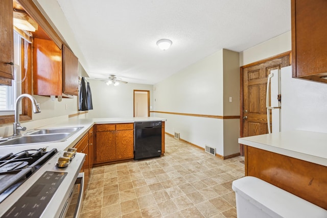 1622 Washington St NE, Minneapolis, MN 55413 - kitchen featuring a sink, freestanding refrigerator, black dishwasher, brown cabinets, and stainless steel gas stove