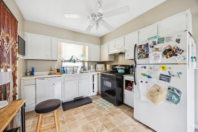 1622 Washington St NE, Minneapolis, MN 55413 - kitchen with white cabinets, under cabinet range hood, light countertops, and white appliances