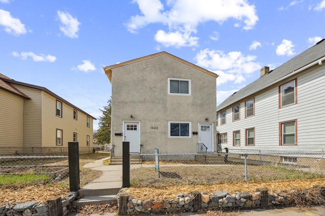 1622 Washington St NE, Minneapolis, MN 55413 - exterior space with a fenced front yard and stucco siding