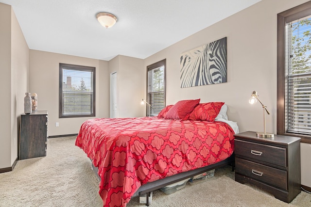 bedroom with carpet floors and baseboards