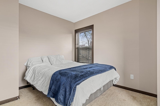 bedroom with baseboards and carpet