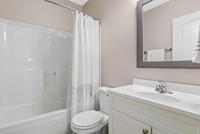 bathroom with vanity, shower / bath combo, and toilet