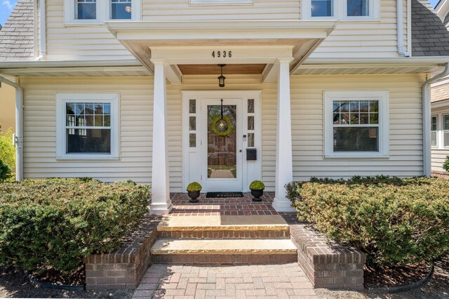 view of exterior entry with a porch
