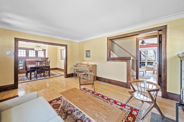 living room with baseboards, ornamental molding, wood finished floors, and a wealth of natural light