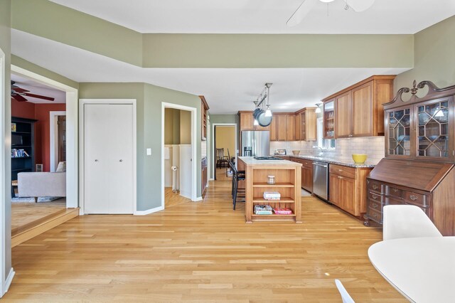 kitchen featuring appliances with stainless steel finishes, open shelves, a ceiling fan, and backsplash