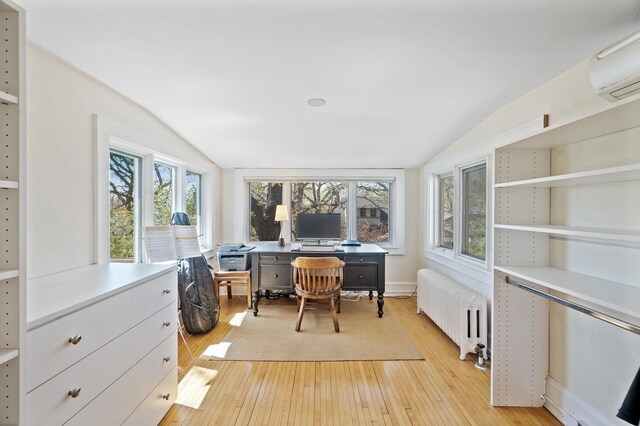 sunroom featuring radiator heating unit and an AC wall unit