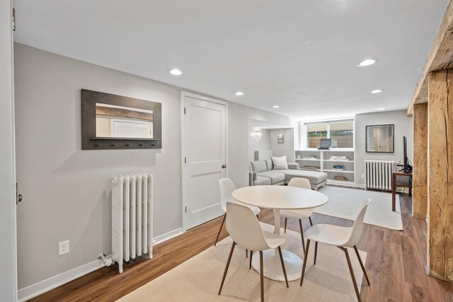 dining room with radiator heating unit, recessed lighting, and wood finished floors
