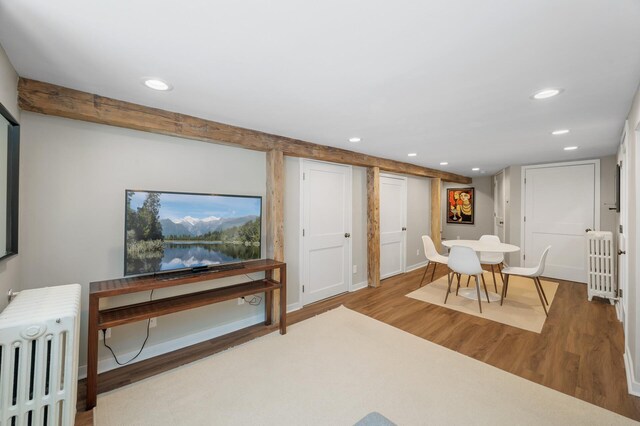 interior space with radiator, recessed lighting, and wood finished floors