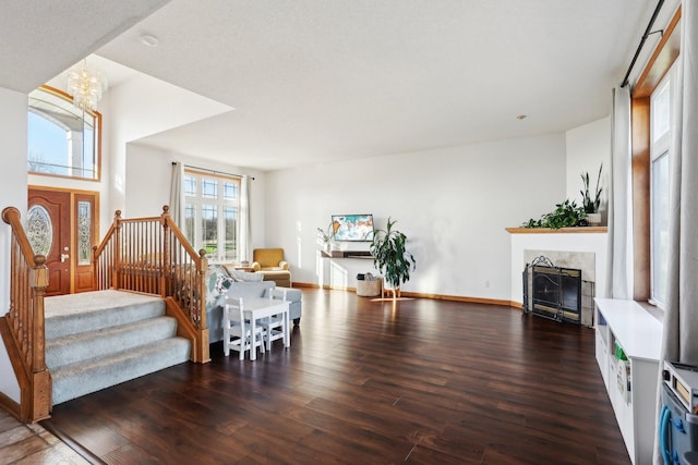 710 Rush Creek Ln, Rush City, MN 55069 - living room featuring stairs, baseboards, a tiled fireplace, and wood finished floors