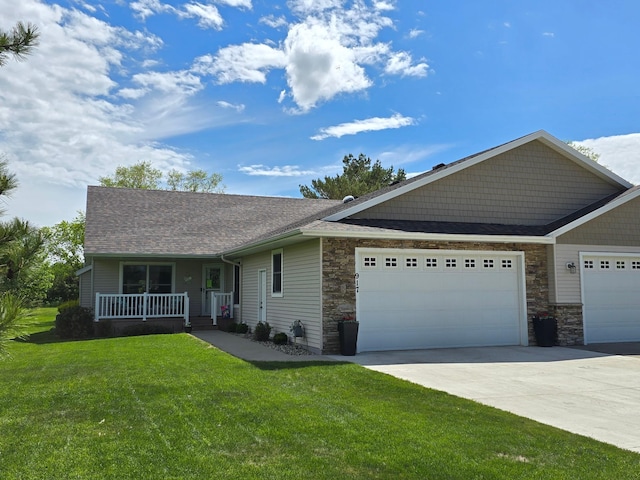 917 Lake Forest Cir, Detroit Lakes, MN 56501 - view of front of home with a porch, a front lawn, an attached garage, driveway, and stone siding