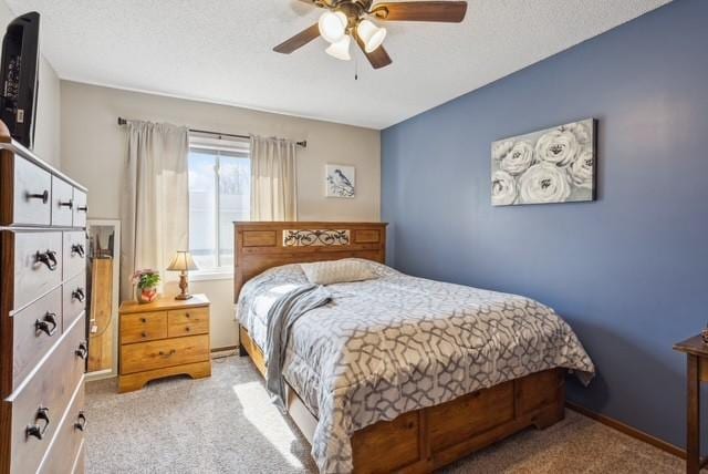 carpeted bedroom with baseboards and a ceiling fan