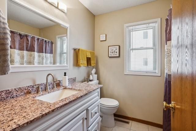 full bathroom featuring tile patterned floors, vanity, curtained shower, baseboards, and toilet