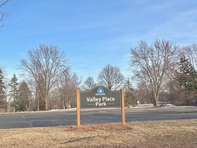 community sign with uncovered parking